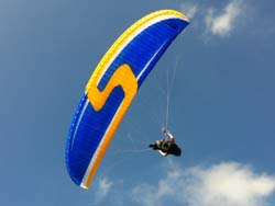 Paraglider flying heigher with turns. 