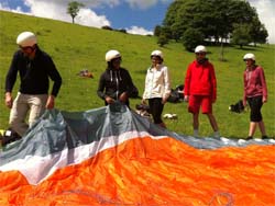Elementary course students inpecting the paraglider.
